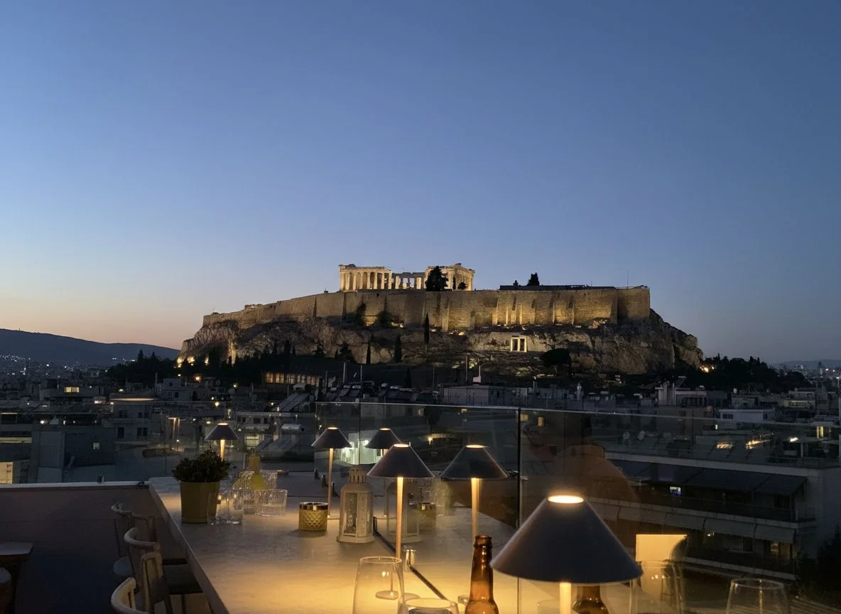 Illuminated Acropolis at night from rooftop bar