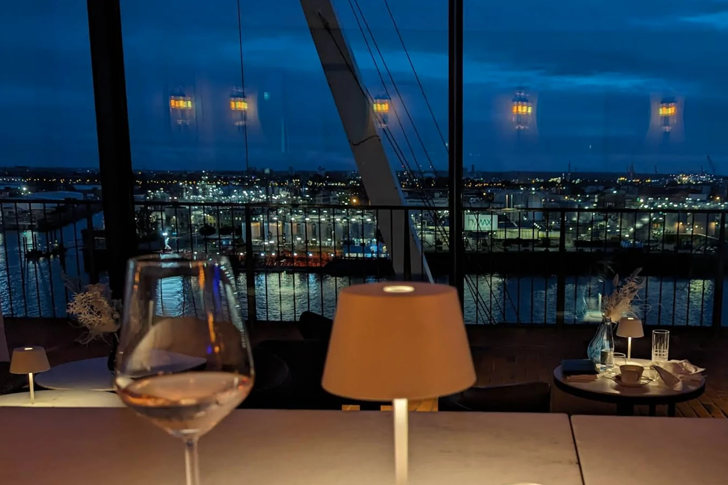Hotel bar with panoramic views of Hamburg and the Elbe River at night