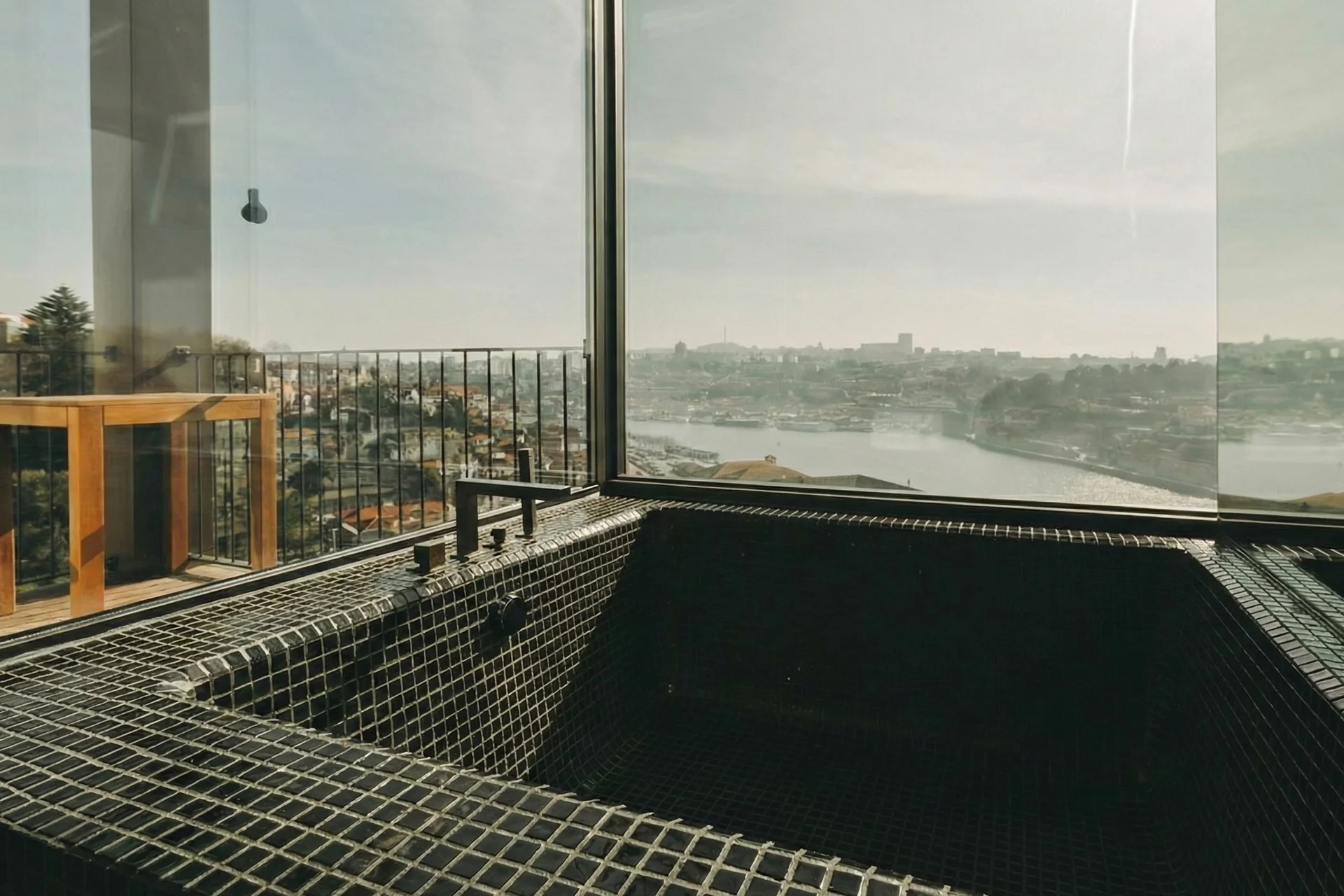 Stone-tiled bathtub with panoramic Douro River and Porto city views